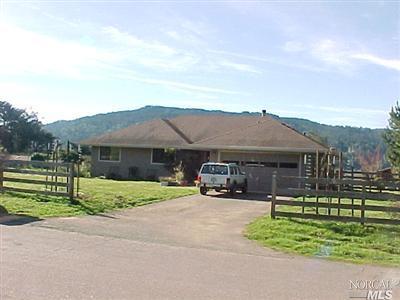6 Ridge View Lane Point Reyes Station, CA 94956 - Photo 1 of 1 a car parked in front of a house next to a yard