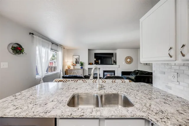 a kitchen with a sink a counter top space cabinets and stainless steel appliances