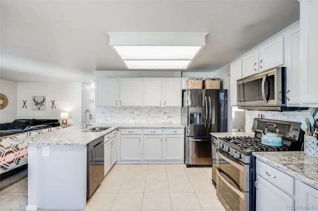 a kitchen with a sink stove and refrigerator