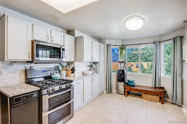 a kitchen with a stove a sink and a microwave