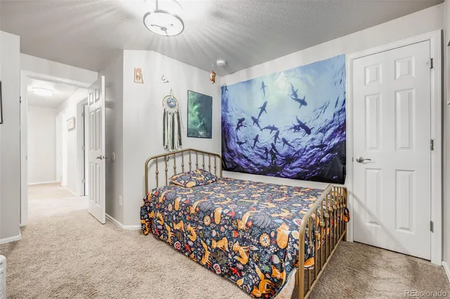 a bedroom with a large bed and a chandelier