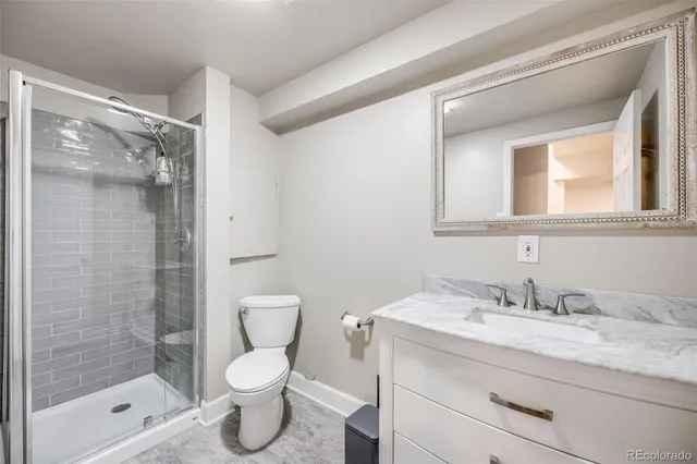 a bedroom with a bed and a lamp on the dresser