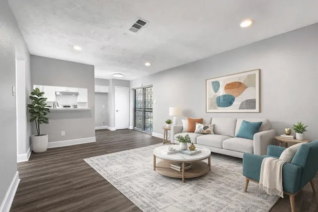 a living room with furniture and wooden floor