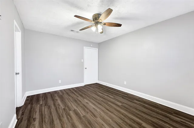 a bathroom with a granite countertop sink toilet and a mirror