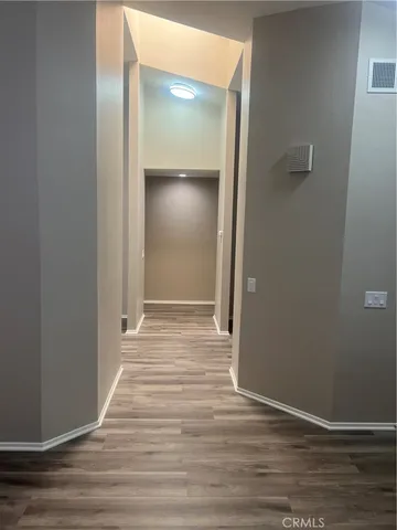 a view of a room with wooden floor