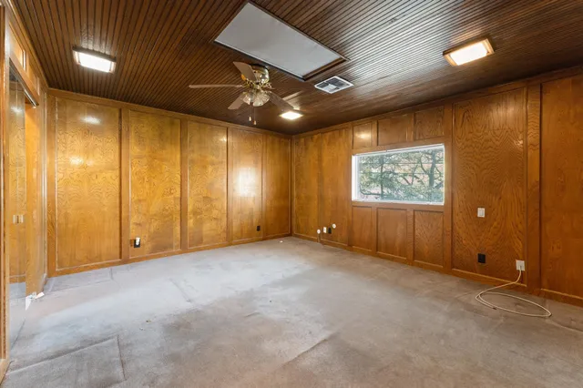 a front view of a house with garden and sitting area
