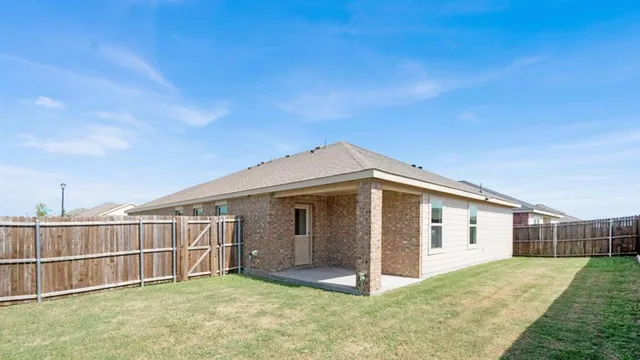 a view of a house with wooden fence