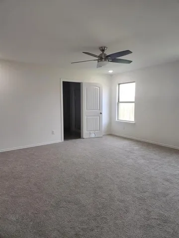 a view of a livingroom with a ceiling fan and window