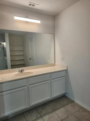 a bathroom with a sink and mirror