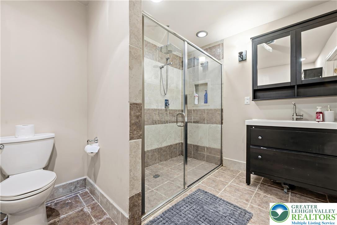 130 Lower Way Road Easton, PA 18045 - Photo 41 of 56 a bathroom with a toilet a sink and glass door