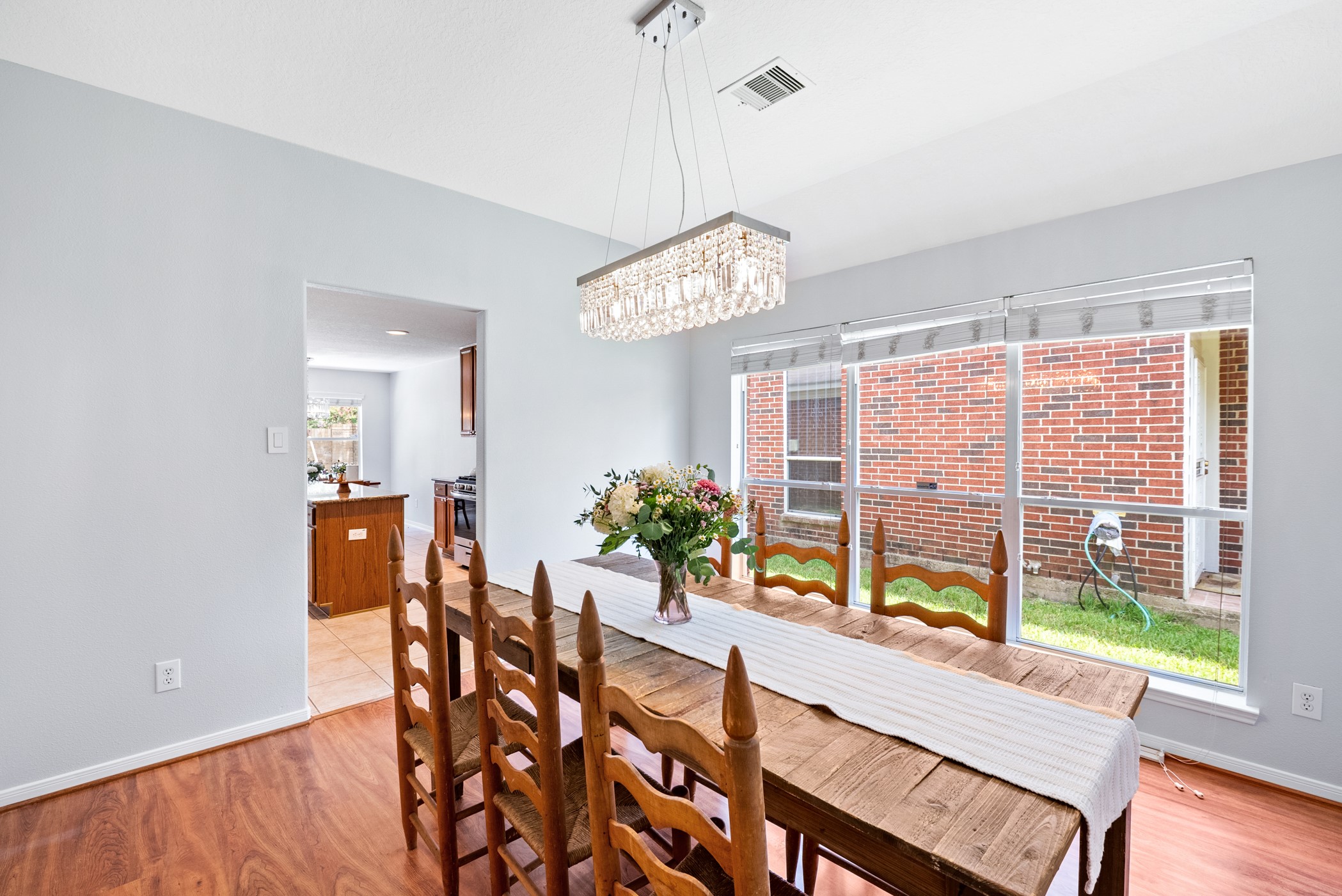 2914 Intrepid Elm Street Houston, TX 77084 - Photo 12 of 32 a view of a dining room with furniture a chandelier and wooden floor