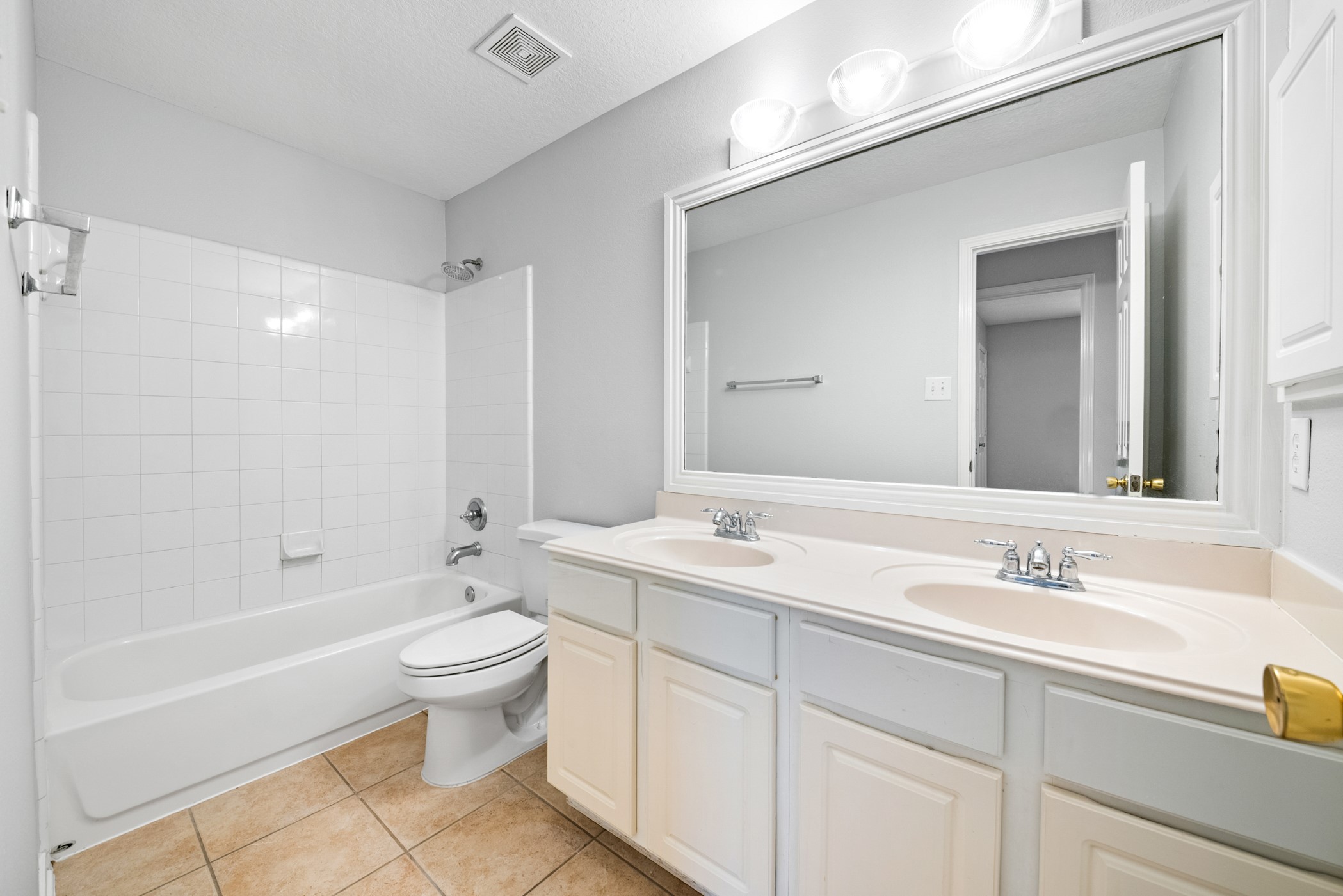 2914 Intrepid Elm Street Houston, TX 77084 - Photo 23 of 32 a bathroom with a toilet a sink a mirror a bathtub and vanity