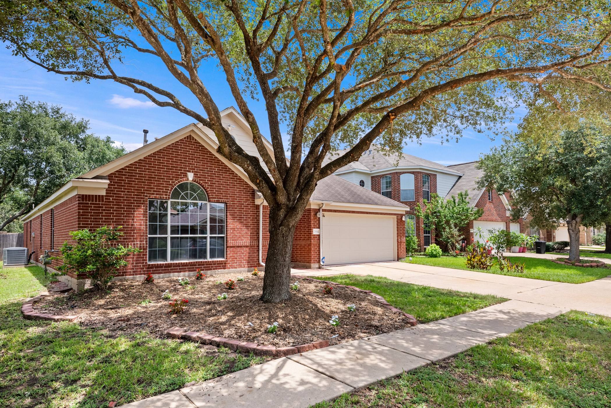2914 Intrepid Elm Street Houston, TX 77084 - Photo 3 of 32 a front view of a house with a yard and garage