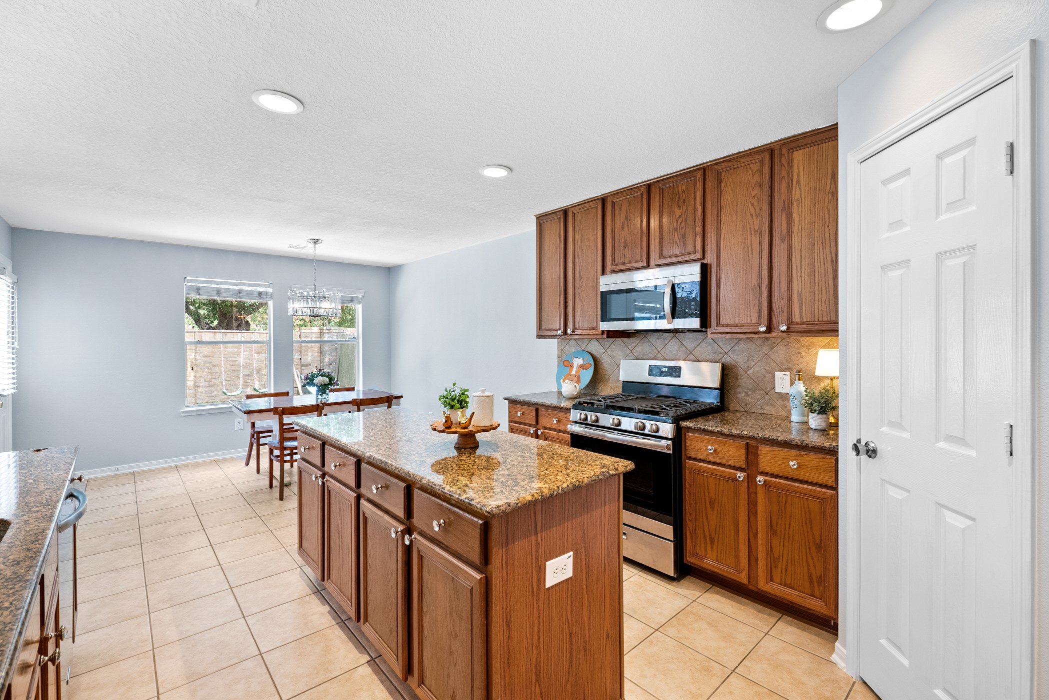 2914 Intrepid Elm Street Houston, TX 77084 - Photo 9 of 32 a kitchen with a sink stove and microwave