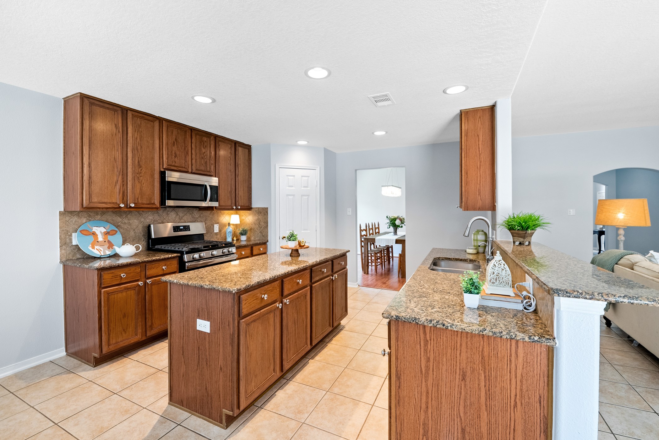 2914 Intrepid Elm Street Houston, TX 77084 - Photo 10 of 32 a kitchen with stainless steel appliances granite countertop a stove top oven a sink dishwasher and a refrigerator