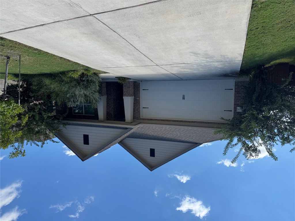 2005 Long Shadow Lane Georgetown, TX 78628 - Photo 1 of 21 View of front of house with roof with shingles, brick siding, a garage, and concrete driveway