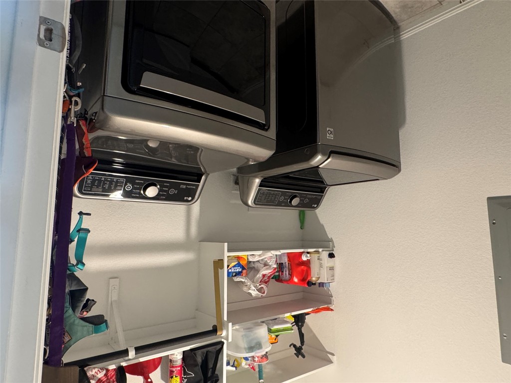 2005 Long Shadow Lane Georgetown, TX 78628 - Photo 11 of 21 Washroom with a textured wall, washer and clothes dryer, and electric panel