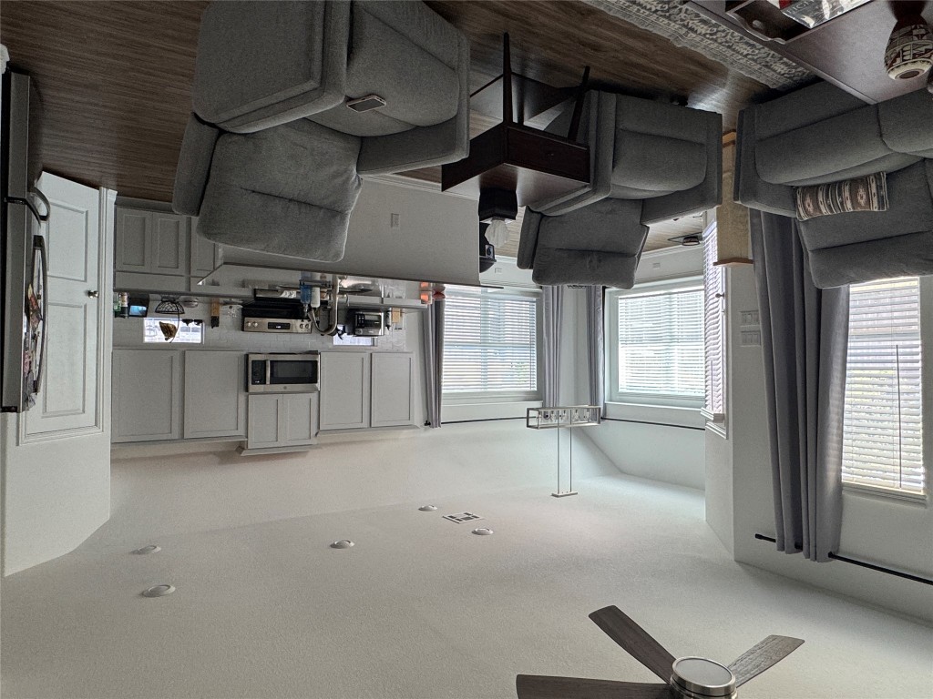 2005 Long Shadow Lane Georgetown, TX 78628 - Photo 15 of 21 Living area with dark wood finished floors, vaulted ceiling, a textured ceiling, ceiling fan, and a chandelier