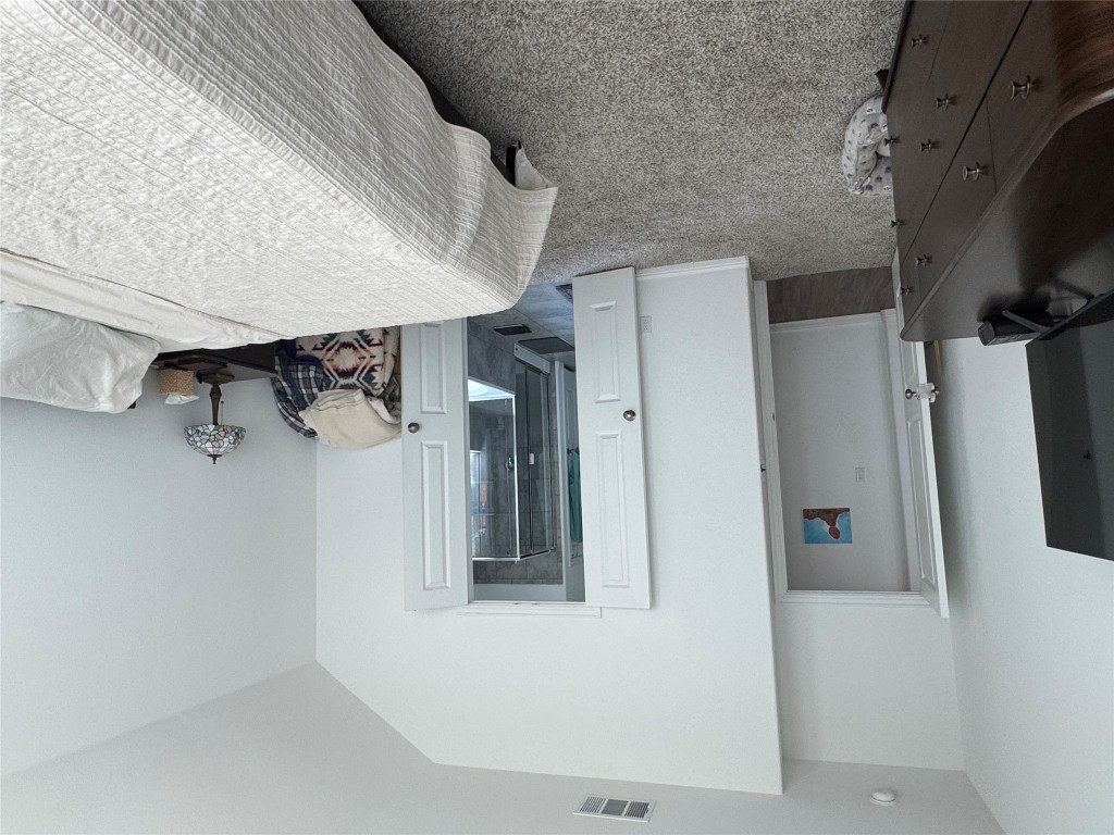 2005 Long Shadow Lane Georgetown, TX 78628 - Photo 18 of 21 Bedroom with light colored carpet, lofted ceiling, and ensuite bath