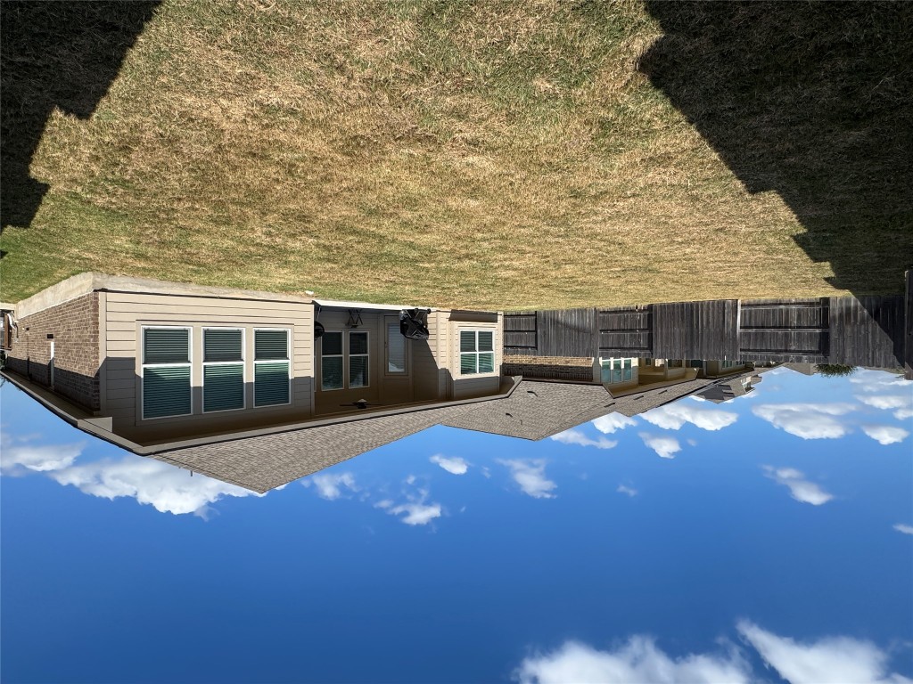 2005 Long Shadow Lane Georgetown, TX 78628 - Photo 20 of 21 Rear view of property with a ceiling fan, a patio, a fenced backyard, brick siding, and roof with shingles