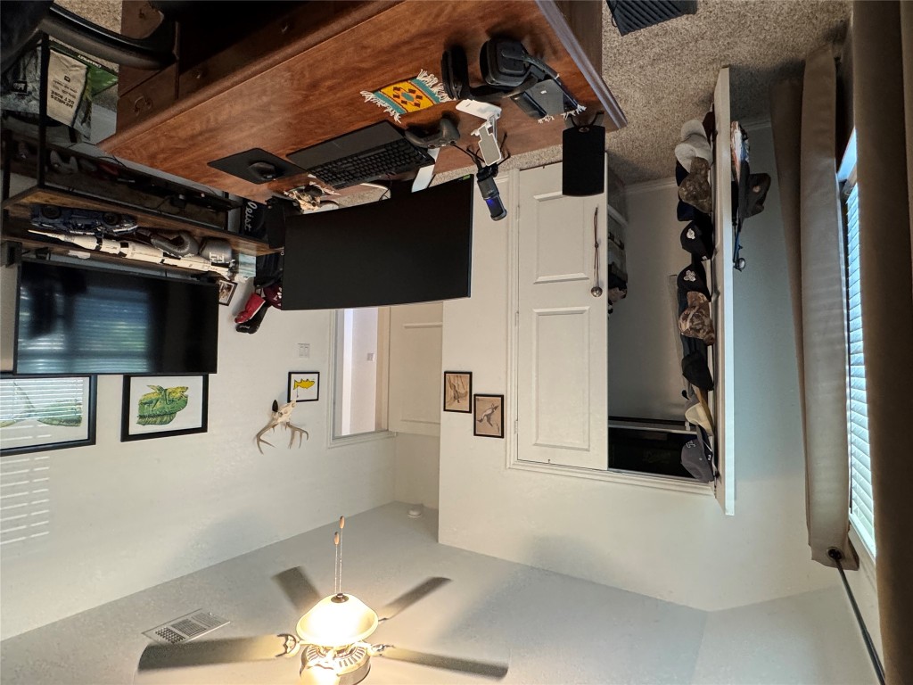 2005 Long Shadow Lane Georgetown, TX 78628 - Photo 5 of 21 Home office with light colored carpet, ceiling fan, and vaulted ceiling