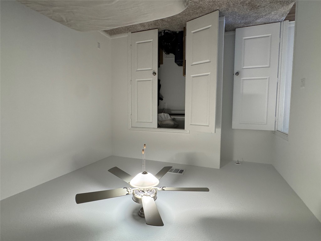 2005 Long Shadow Lane Georgetown, TX 78628 - Photo 7 of 21 Bedroom featuring carpet, a closet, and a ceiling fan