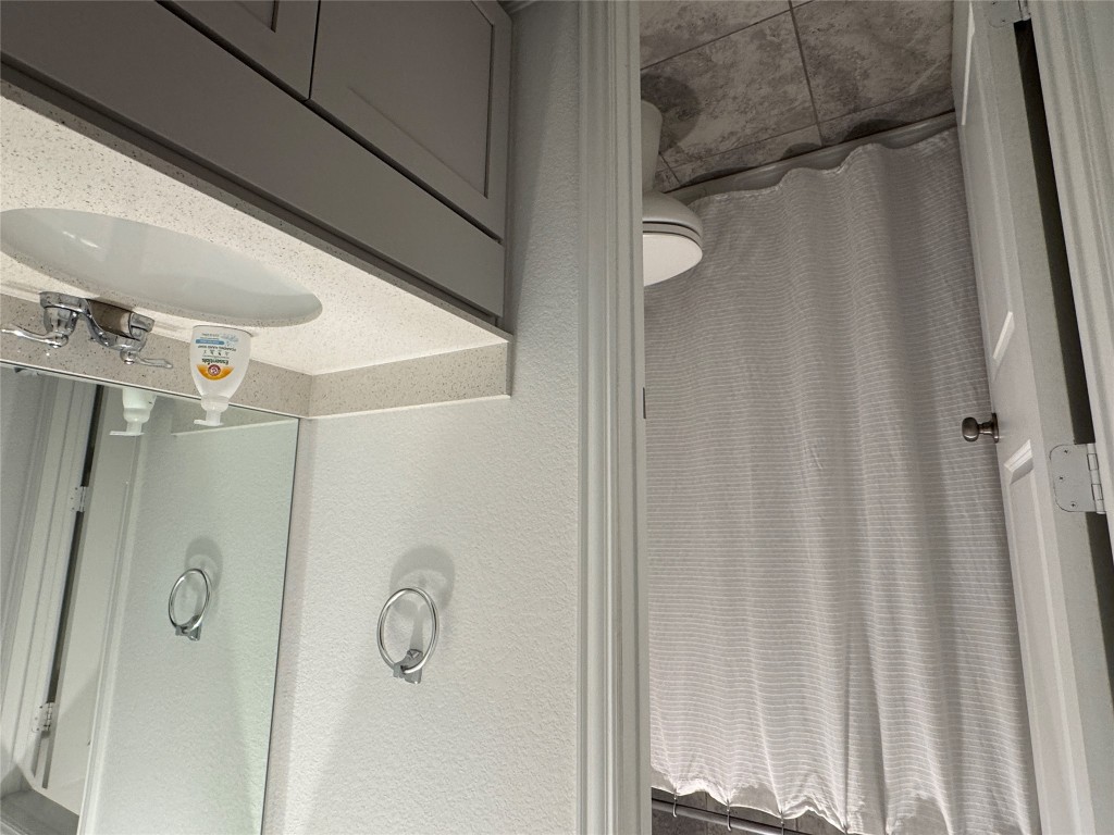 2005 Long Shadow Lane Georgetown, TX 78628 - Photo 8 of 21 Bathroom with a textured wall, vanity, and light tile patterned floors