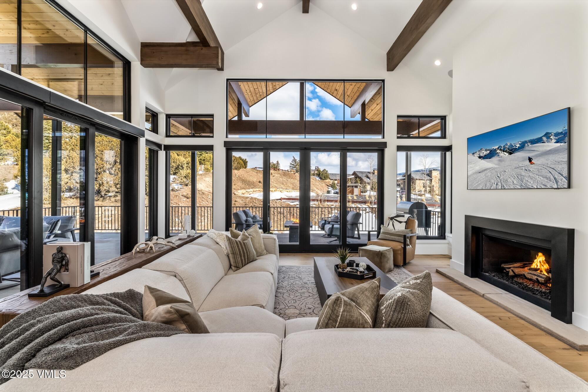 100 Legends Drive, Unit D Edwards, CO 81632 - Photo 3 of 37 a living room with furniture a fireplace and floor to ceiling windows