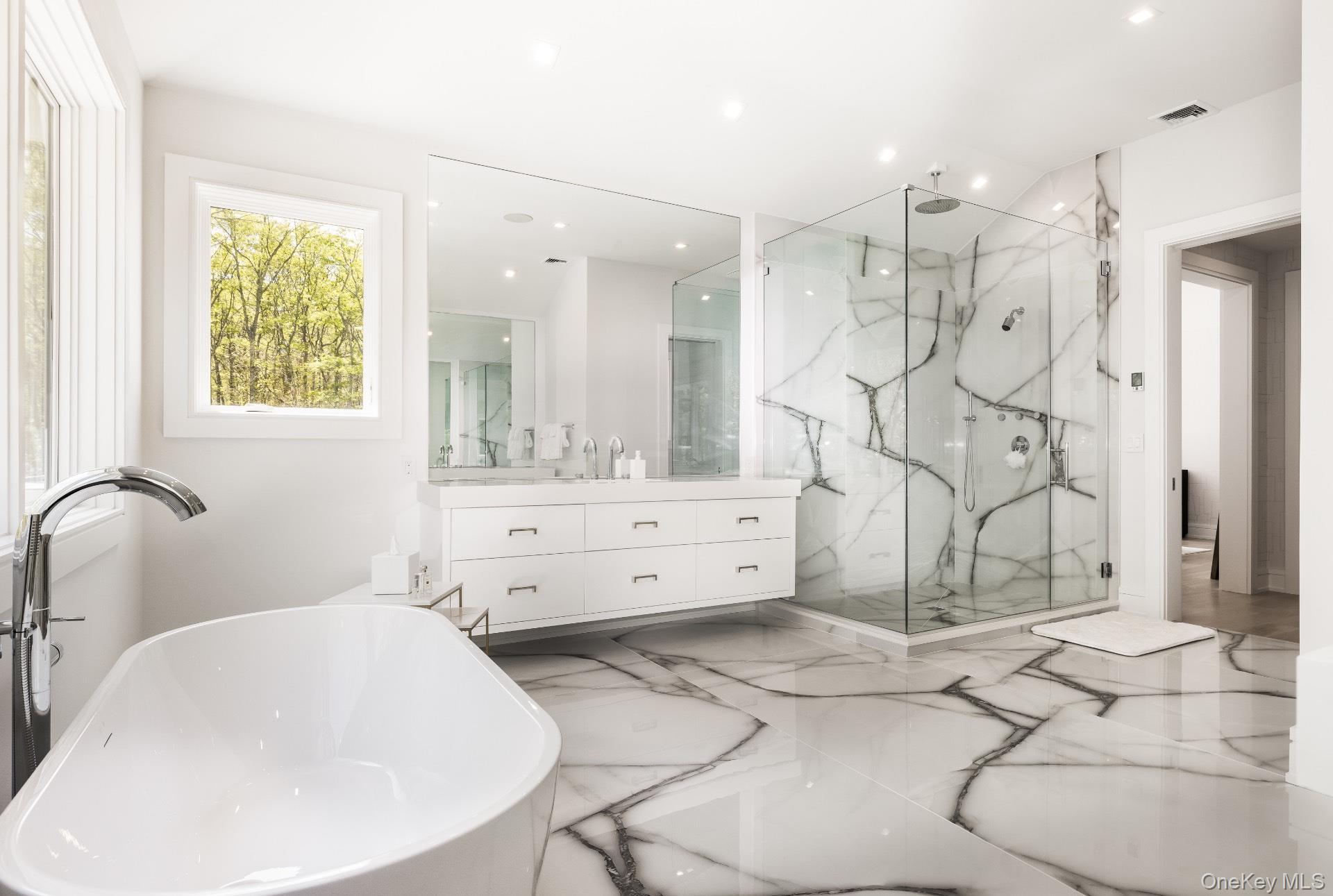 1552 Deerfield Road Water Mill, NY 11976 - Photo 27 of 37 a bathroom with a sink mirror and a shower