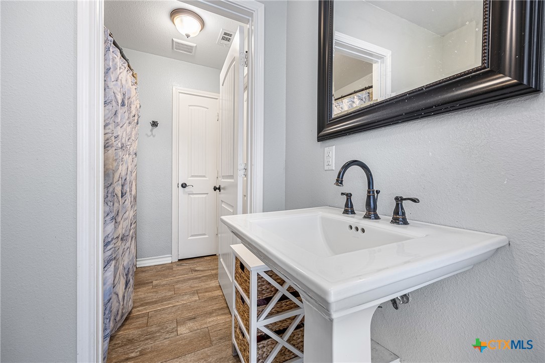 16101 Dove Road Moody, TX 76557 - Photo 27 of 42 a white sink sitting under a bathroom mirror