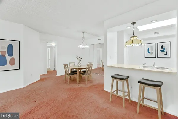 a view of kitchen with furniture and chandelier