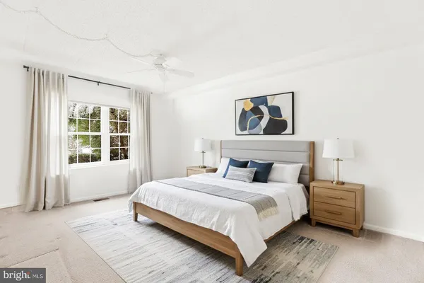 a bedroom with a bed and a large window