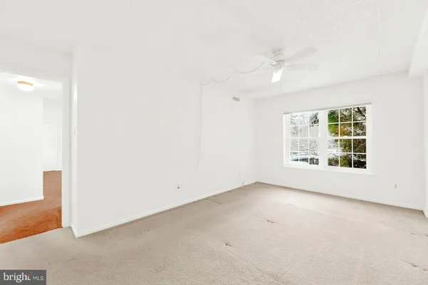 an empty room with windows and entrance