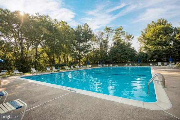 a view of a swimming pool with a yard