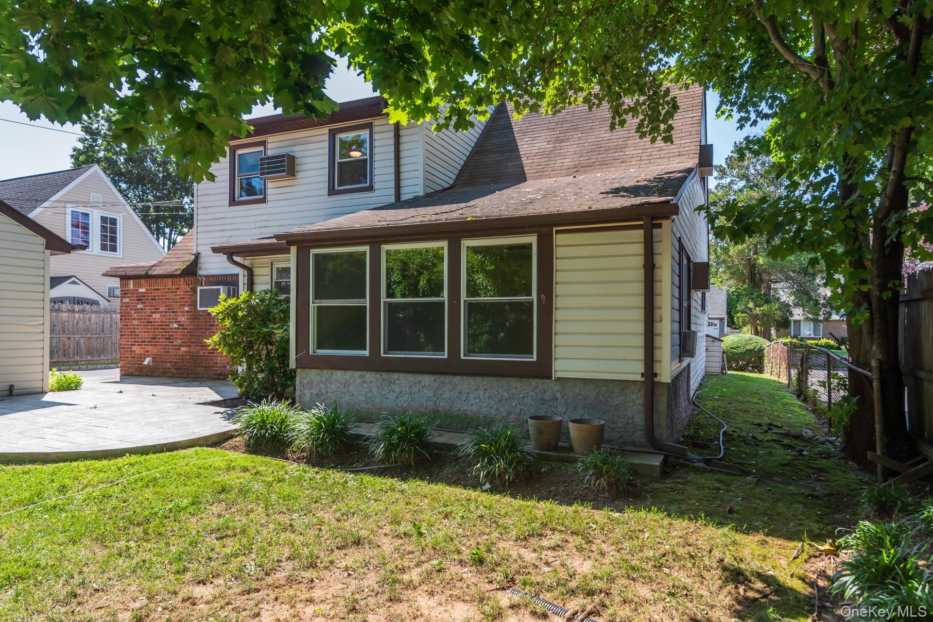 27 Collins Road Glen Cove, NY 11542 - Photo 12 of 13 a front view of a house with garden