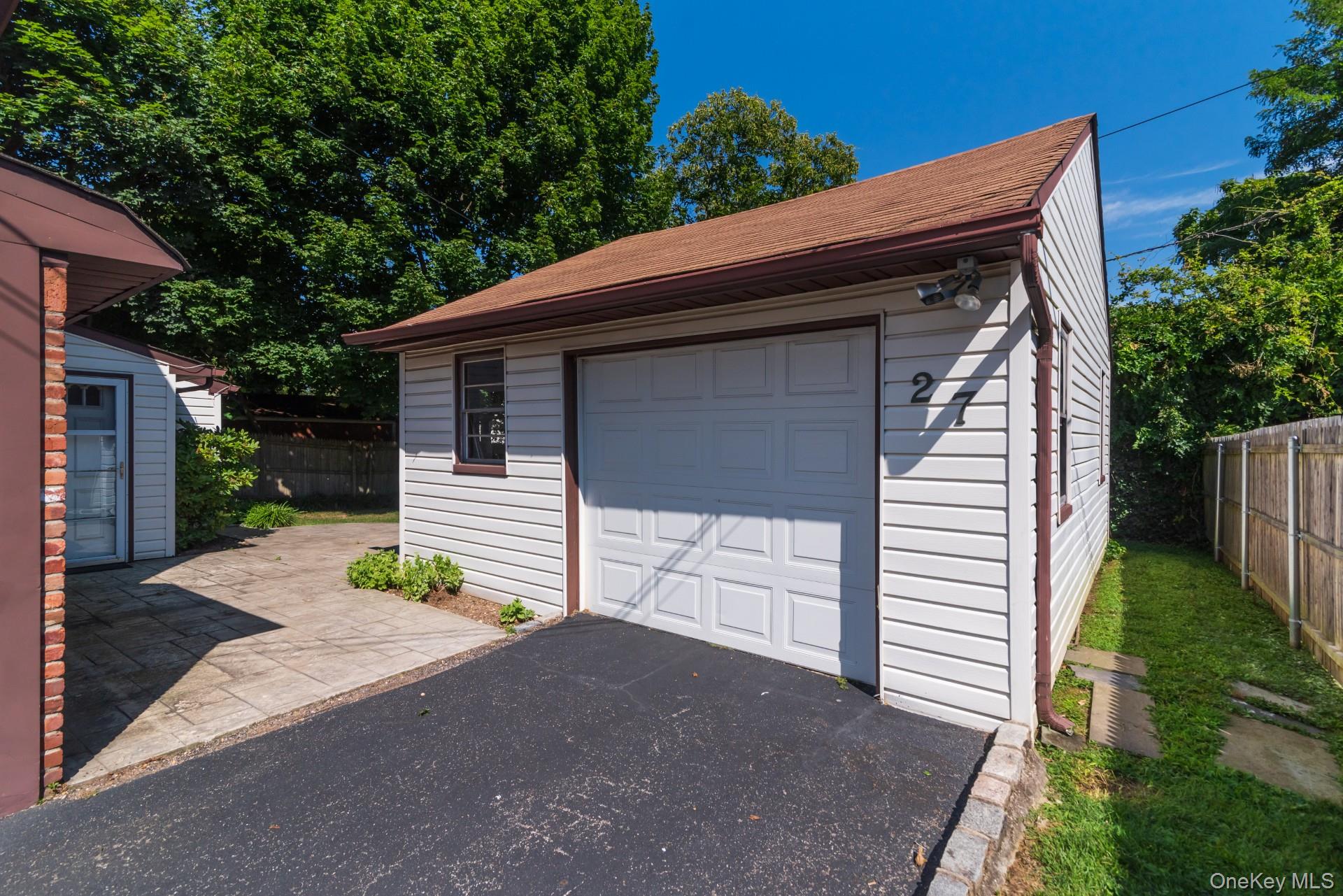 27 Collins Road Glen Cove, NY 11542 - Photo 3 of 13 a front view of house with yard and trees in the background