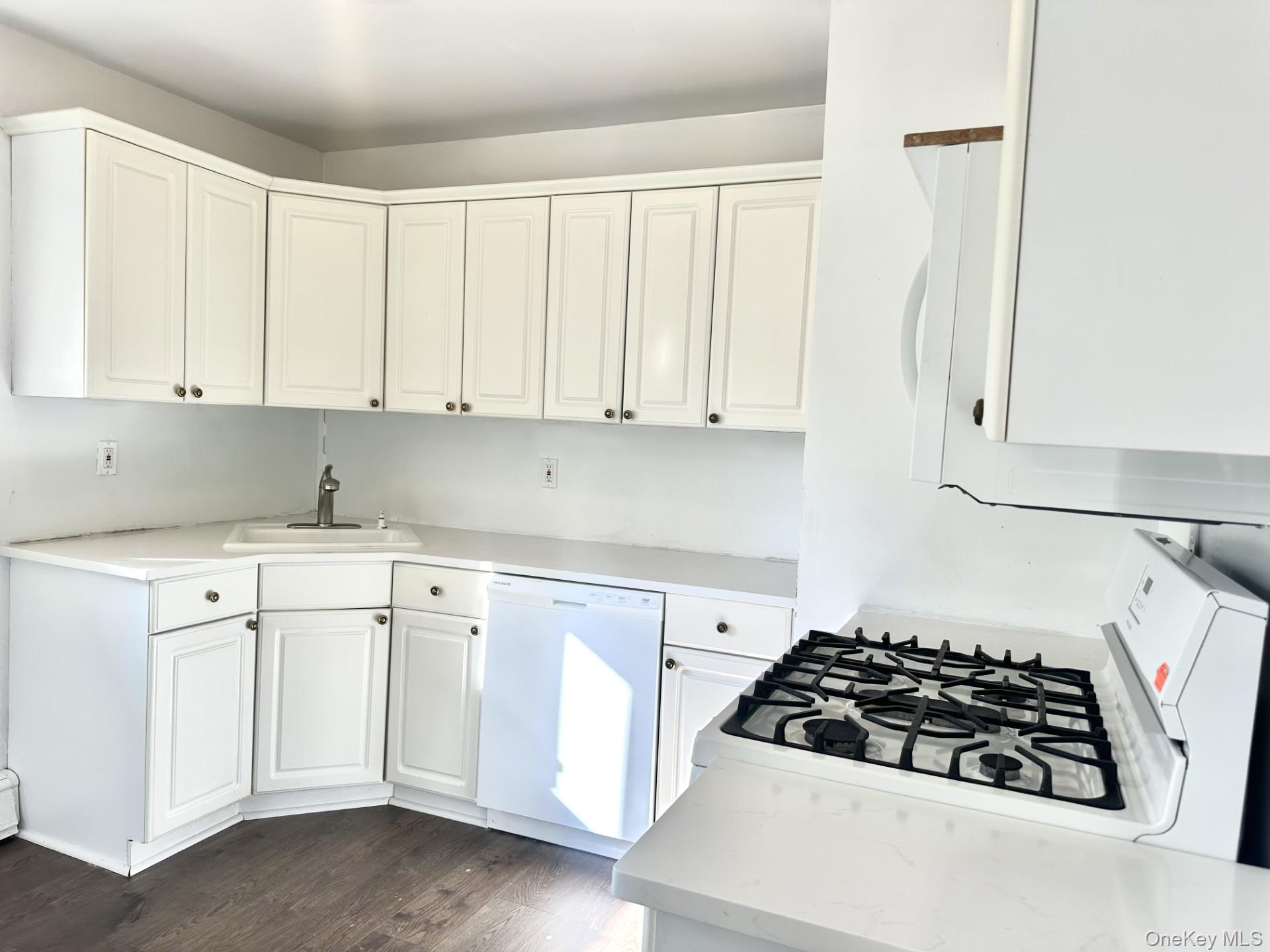 27 Collins Road Glen Cove, NY 11542 - Photo 9 of 13 a kitchen with white cabinets and white stove
