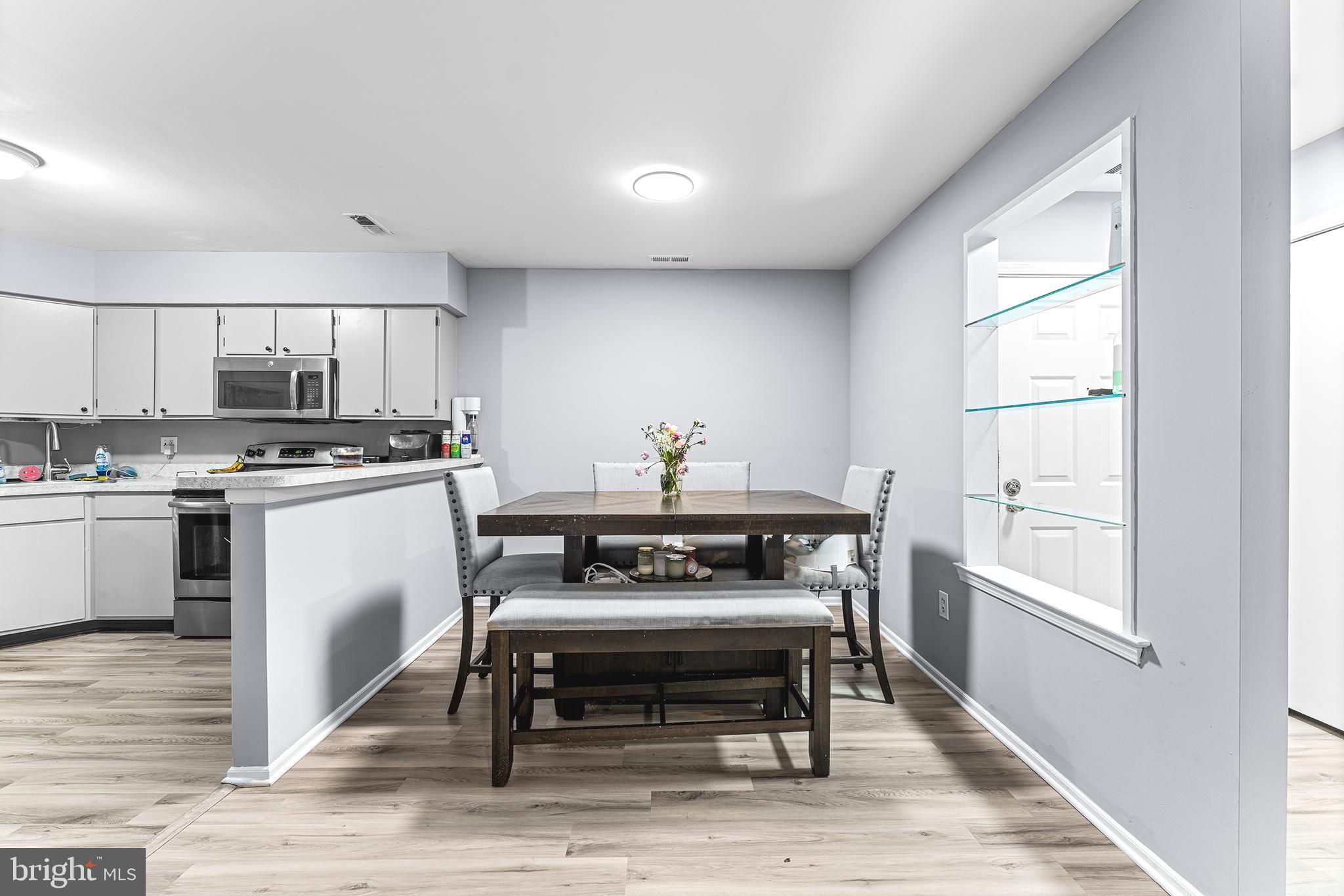 16 Devon Place Sewell, NJ 08080 - Photo 7 of 22 a kitchen with a stove a sink and a microwave