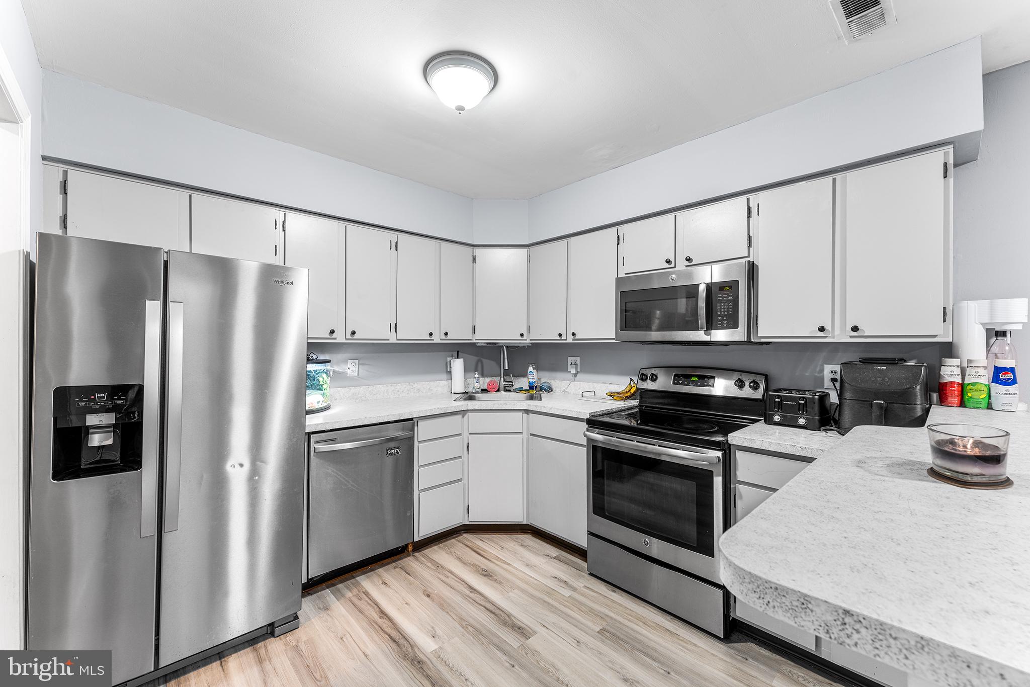 16 Devon Place Sewell, NJ 08080 - Photo 8 of 22 a kitchen with stainless steel appliances a refrigerator sink and cabinets