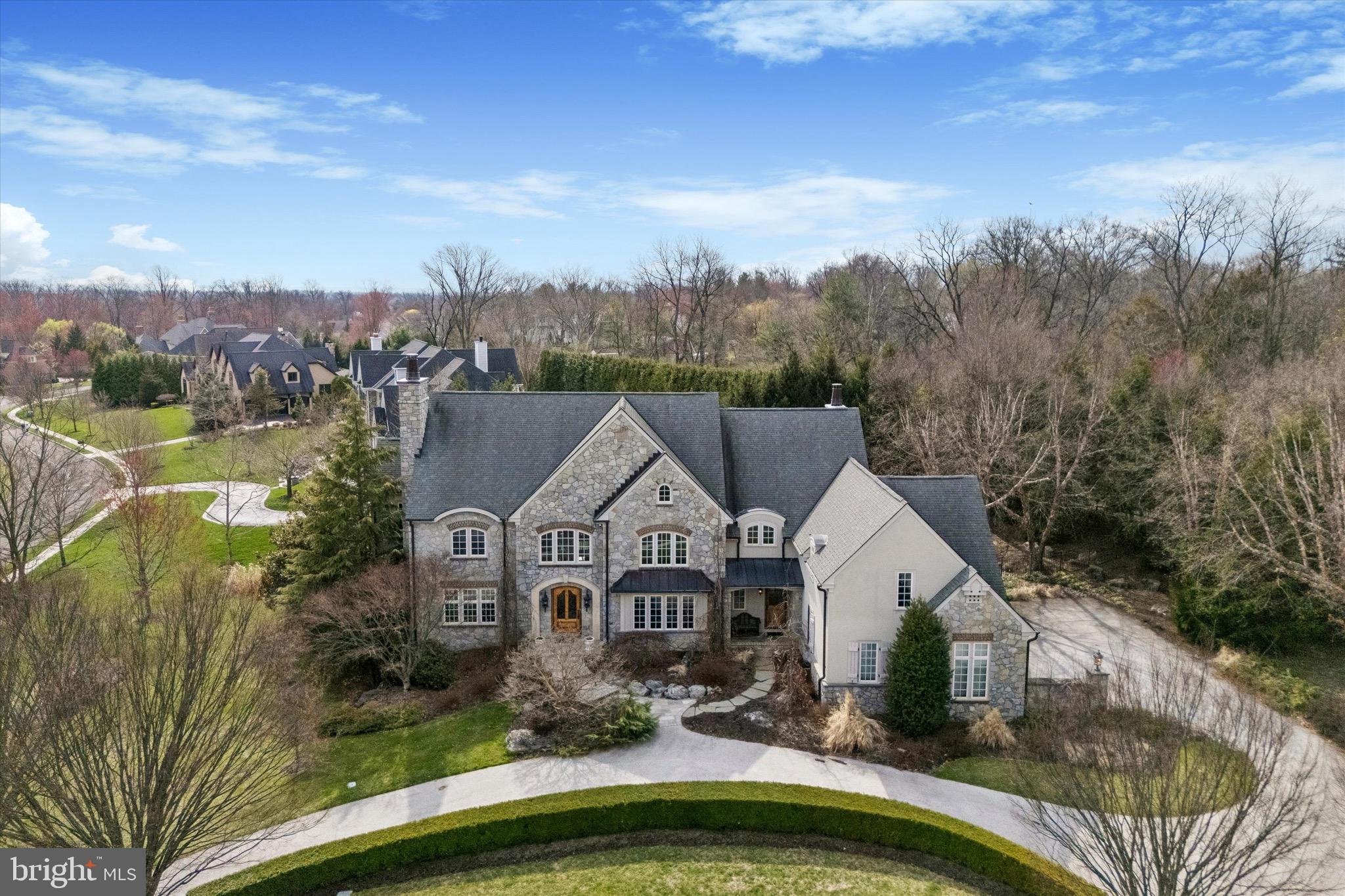 a view of a house with a big yard and large trees