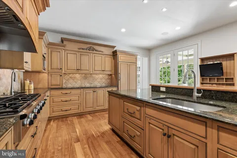 a kitchen with granite countertop a stove and a sink