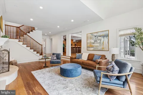 a living room with furniture and a dining table