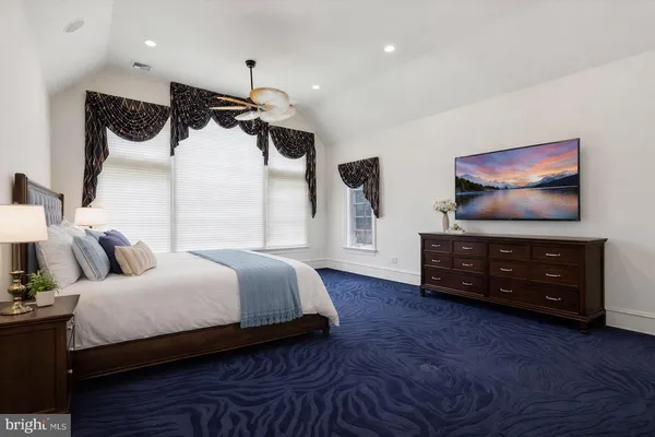 a bedroom with bed and a flat screen tv