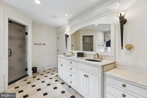 a spacious bathroom with a sink a mirror a vanity and a shower