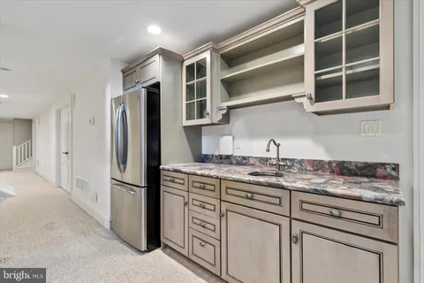 a kitchen with stainless steel appliances granite countertop a refrigerator and a sink