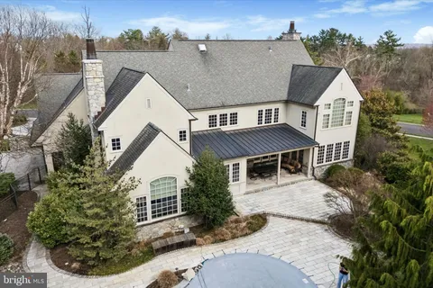 an aerial view of a house with a yard and potted plants