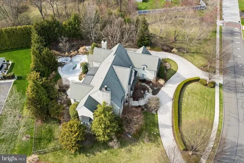 an aerial view of a house with swimming pool and garden view