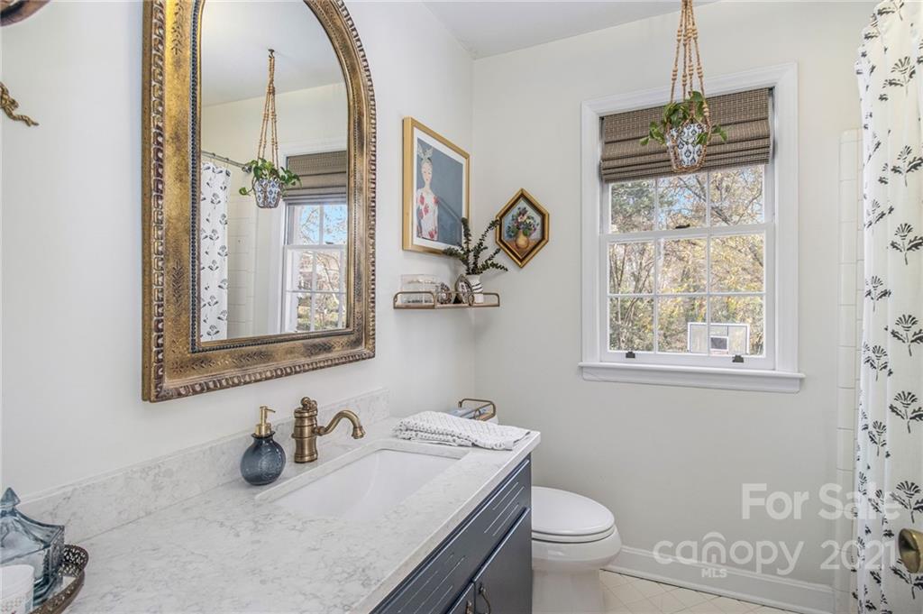 3513 Highview Road Charlotte, NC 28210 - Photo 16 of 27 a bathroom with a sink a toilet and a mirror