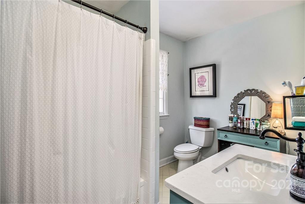 3513 Highview Road Charlotte, NC 28210 - Photo 21 of 27 a living room with furniture a toilet and a sink