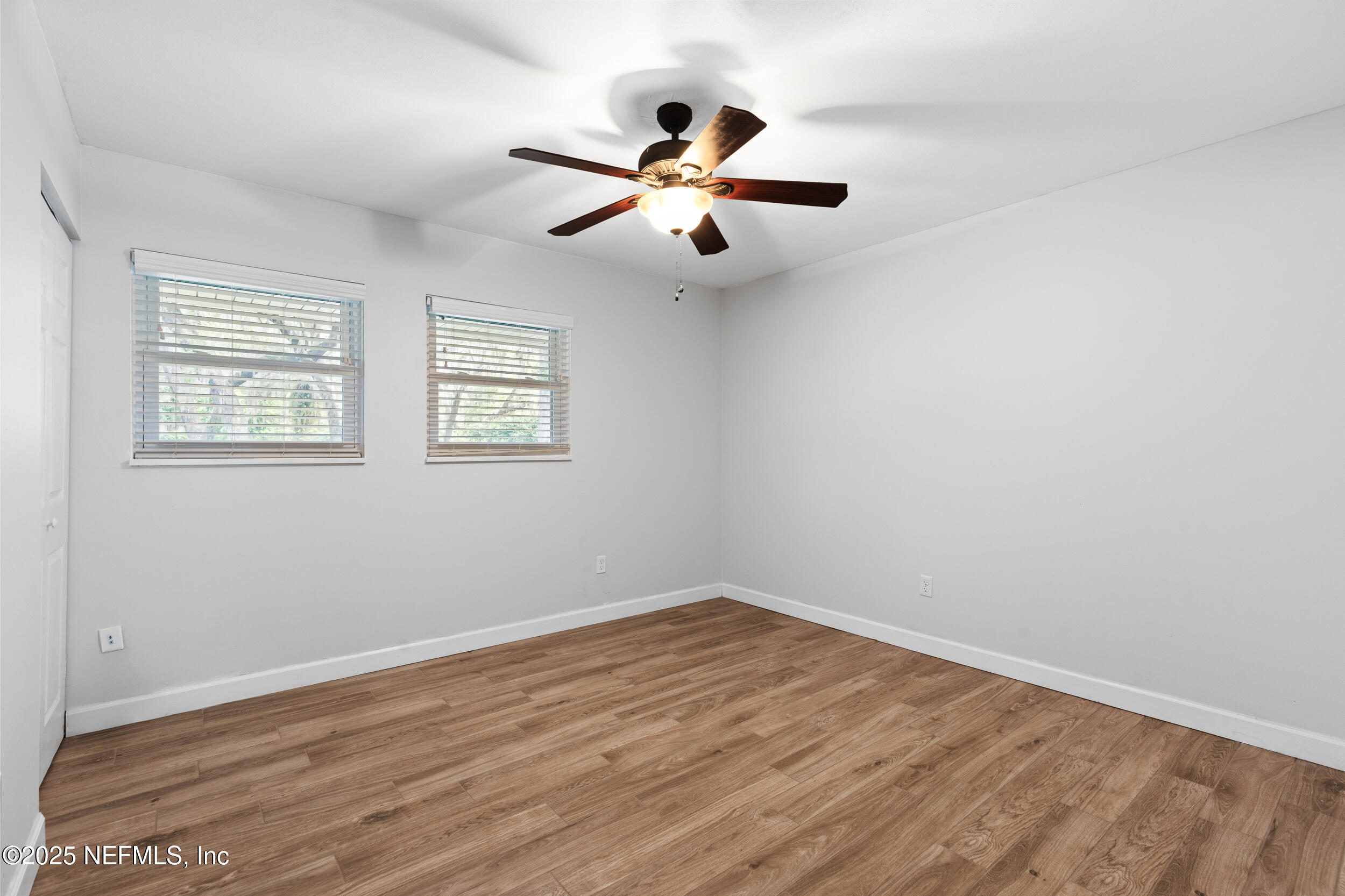 49 Nelsons Point Keystone Heights, FL 32656 - Photo 17 of 34 an empty room with wooden floor fan and windows